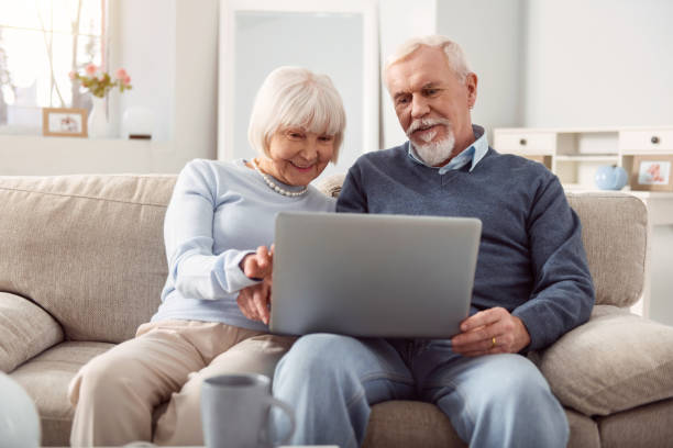 istock Pleasant senior couple surfing Internet on laptop together 935614516