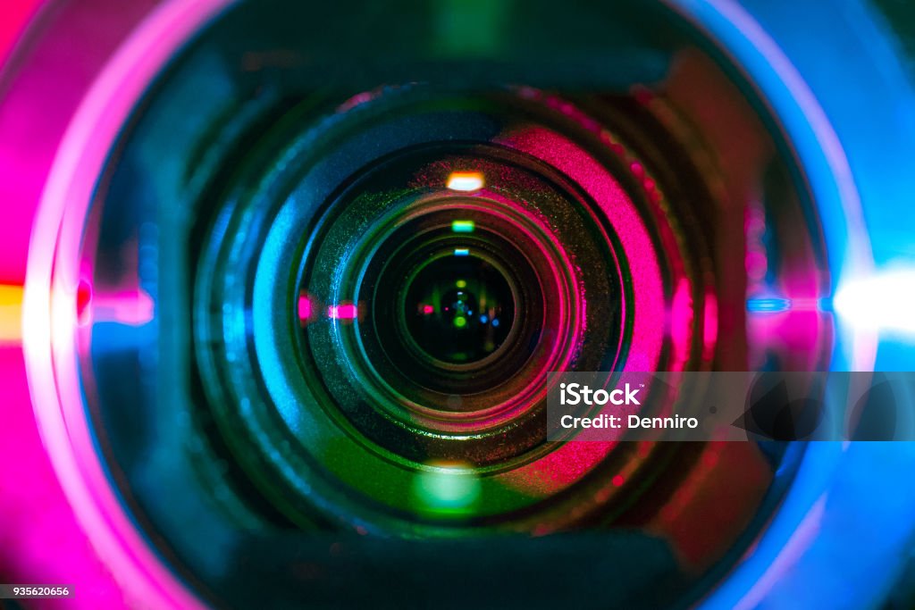 Video camera lens Video camera lens lit by different color light sources Home Video Camera Stock Photo