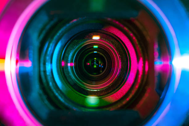 Video camera lens Video camera lens lit by different color light sources reportage stock pictures, royalty-free photos & images