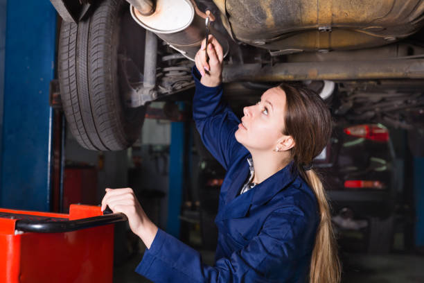 istock Female master is repairing car on her workplace 935628440