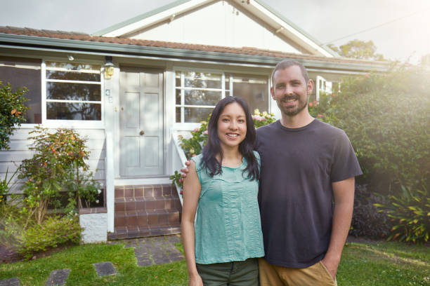 istock Happy mixed-race couple standing outside their house 935639482