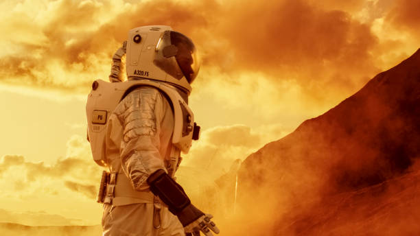 istock Proud Astronaut Confidently Walks on Mars Surface. Red Planet Covered in Gas and rock,  Overcoming Difficulties, Important Moment for the Human Race. 935640076