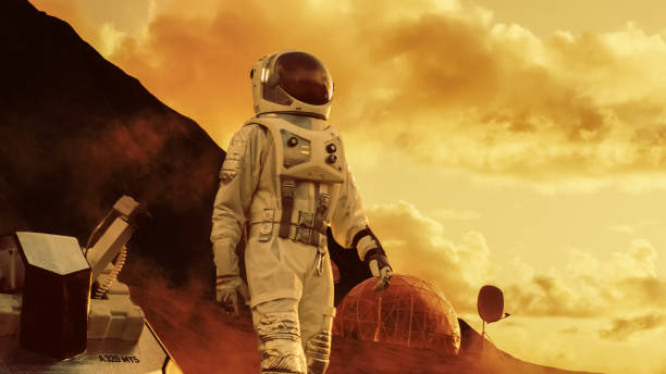 istock Astronaut on Mars Walking on the Exploring Expedition. In the Background His Base/ Research Station. First Manned Mission To Mars, Technological Advance Brings Space Exploration, Colonization. 935640122