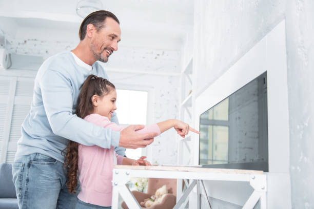 istock Delighted positive man holding his daughters hand 935640380