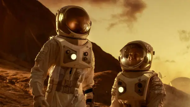 Photo of Two Astronauts Talking while Exploring Mars/ Red Planet. Space Exploration, Adventure and Colonisation Theme.