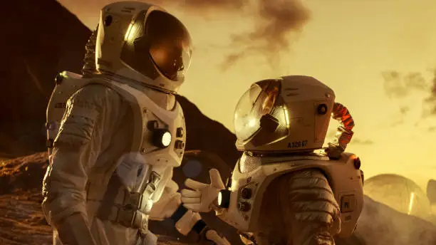 Photo of Two Astronauts Talking while Exploring Mars/ Red Planet. Space Exploration, Adventure and Colonisation Theme.