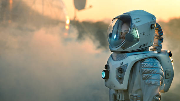 strzał astronauty na marsie idąc w kierunku jego bazy / stacji badawczej, rozglądając się. pierwsza załogowa misja na marsa, postęp technologiczny przynosi eksplorację kosmosu, kolonizację. - people exploration futuristic walking zdjęcia i obrazy z banku zdjęć