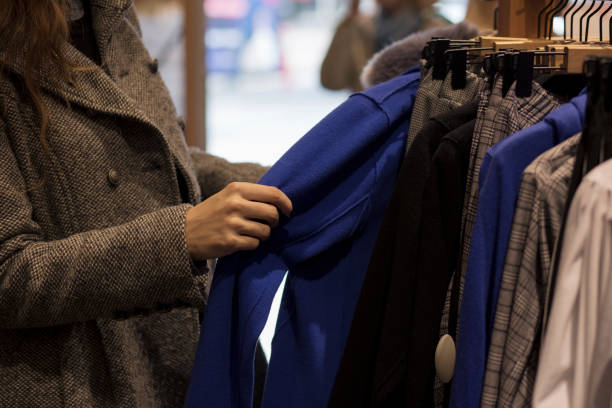 istock Woman choosing clothes on rack 935640608