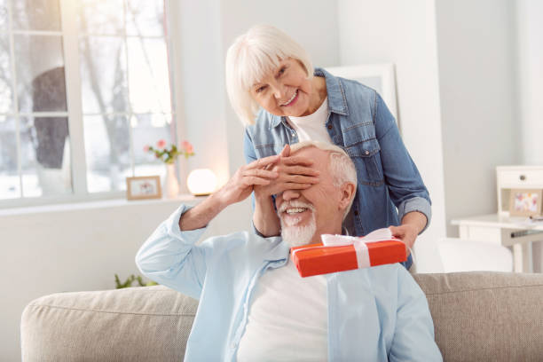 istock Loving wife making birthday surprise for her husband 935640664