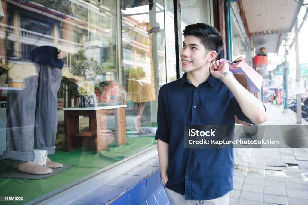 Young Asian Man going out for shopping Shopping Mall Stock Photo