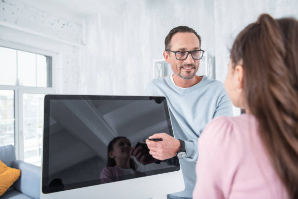 istock Positive pleasant man showing the digital screen 935643520