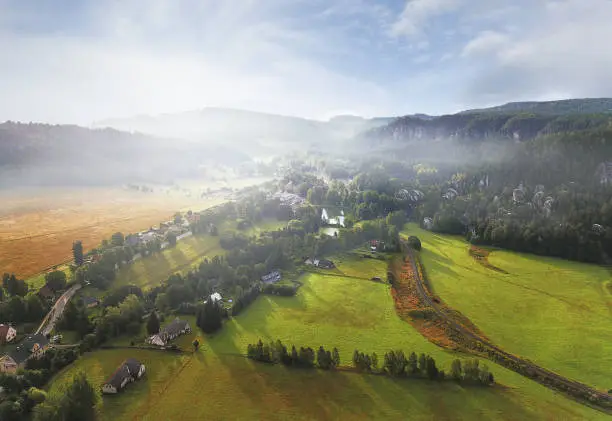 Drone point of view at picturesque misty valley of Adrspach Teplice rocks in the autumn morning sun. The Adršpach-Teplice Rocks climbing area (Czech: Adršpašsko-teplické skály, German: Adersbach-Weckelsdorfer Felsenstadt) are an incredibul set of sandstone formations.