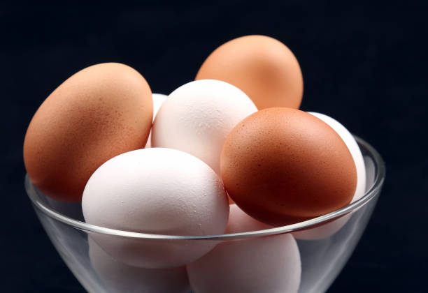 istock chicken eggs lie in plate on dark background 935643710