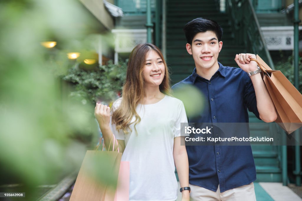 Young Asian Couple going out for shopping Shopping Stock Photo