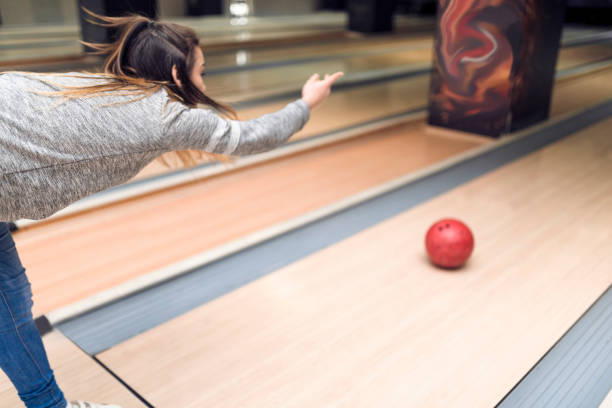 istock Young woman playing bowling close-up 935644042