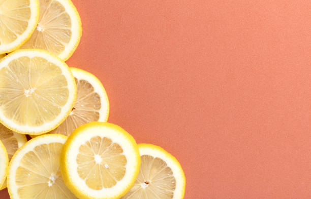 istock slices of lemon on salmon background 935649380