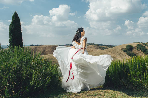 Pretty happy bride in luxury dress outdoors