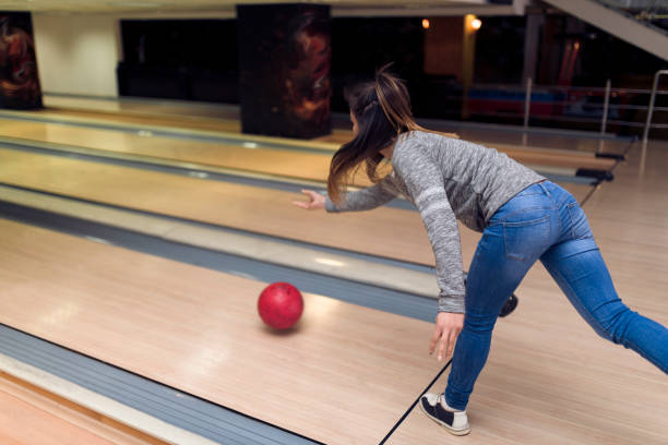 istock Pretty young woman playing bowling 935650154