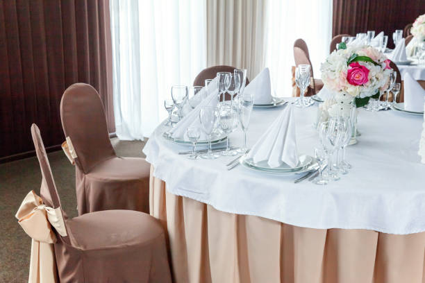 istock Table with glasses and napkins served for dinner in restaurant 935653132