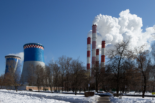 Thermal power plant in Moscow - smoke comes from a pipe, on a street in winter