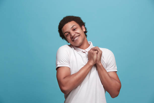 istock Handsome man looking suprised isolated on blue 935658478