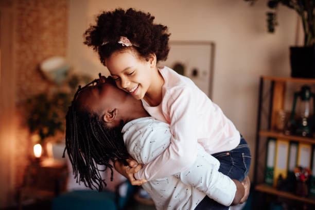 istock Mom and daughter hugging and kissing 935658814