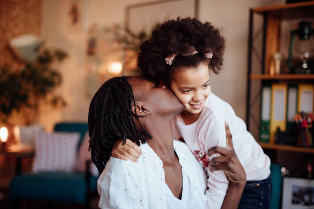 istock Mom and daughter hugging and kissing 935659178