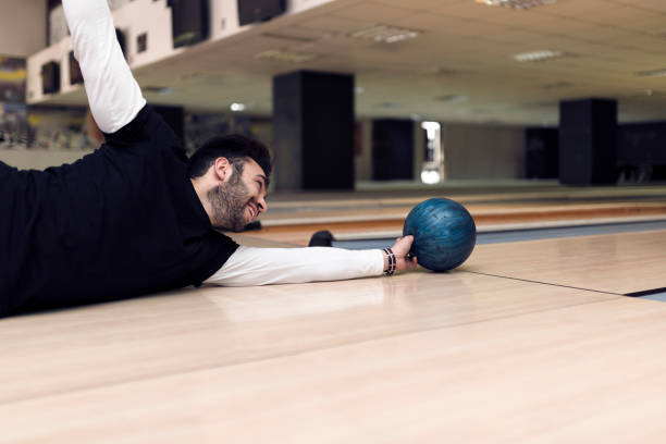 istock Handsome bearded man having fun at the bowling alley 935659370