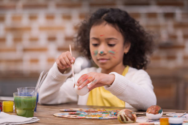 istock african american kid painting easter egg 935661950