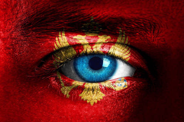 istock Human face painted with flag of Montenegro 935664600