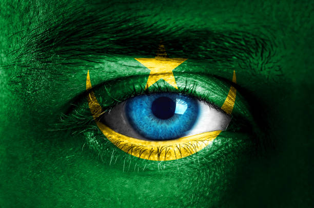 istock Human face painted with flag of Mauritania 935668522