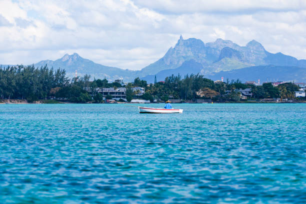 fisherman is fishing in the lagoon of trous aux biches on mauritius island in africa.\nNOTE TO INSPECTOR: file was rejected and suggested as editorial, than from editorial inspectors rejected and suggested as creative…