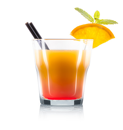 Mimosa cocktail in old fashioned glass with slice of orange, mint and black straw isolated on white background. Clipping path