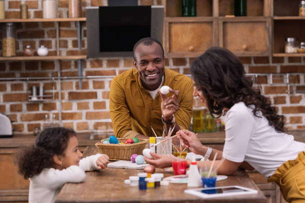 istock happy african american family painting easter eggs at kitchen 935674342