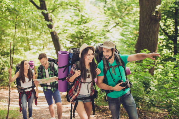 istock Check it out! Young excited tourists are walking in the spring canyon, having all needed for camping, talking, relaxing 935677202