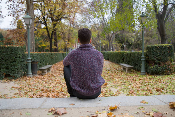 istock Thoughtful man on stairs in park 935678282