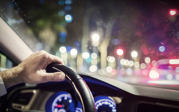 istock Man driving at night in the city 935681042