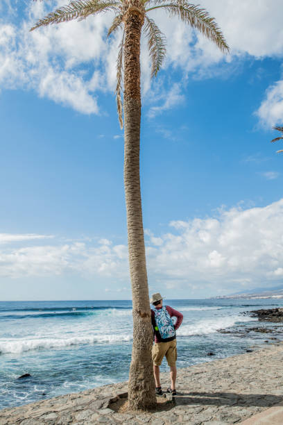 istock Senior man exploring Tenerife Beach Playa de Las Americas 935681434