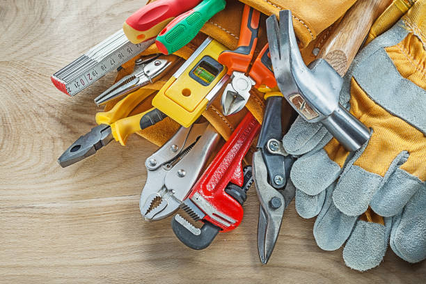 istock Tools in leather building belt on wooden board top view 935681862