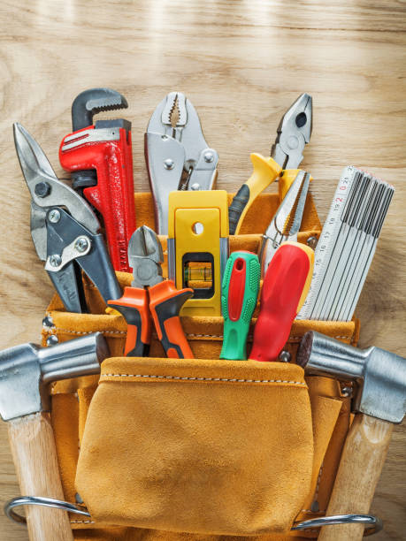 istock Tools in leather toolbelt on wooden board top view 935681910