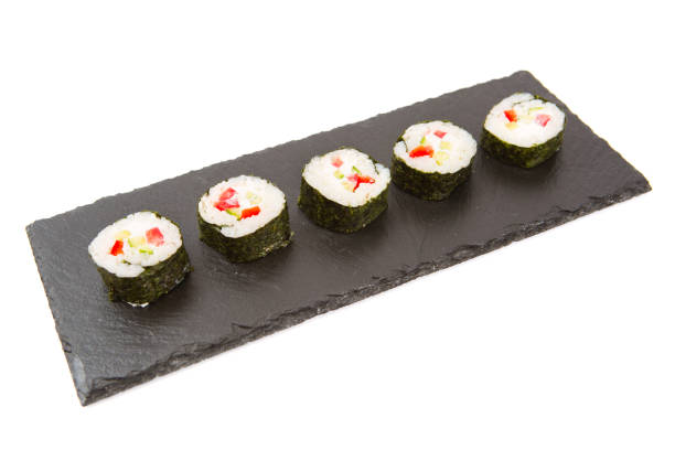 istock Sushi isolated on shale food board on white background 935684884