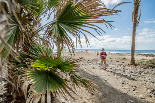 istock Senior man exploring Tenerife Beach Playa de Las Americas 935685626