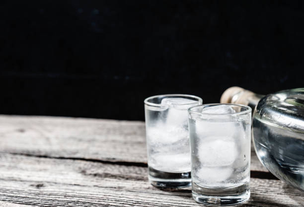 istock Cold vodka in shot glasses on a black background 935691362