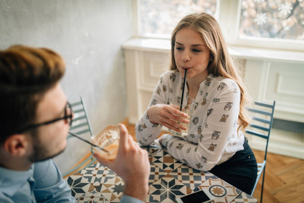 istock Lovely young couple having a date in cafe and drinking coffee 935691610