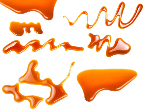 istock Caramel splashes isolated on white background. Spilled caramel sauce, toffee toppings 935692506