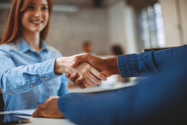 istock Young woman signing contracts and handshake with a manager 935692534