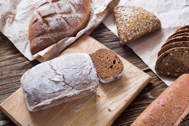 istock Different bread on table close-up. healthy bread on wooden background, craft paper. 935695896