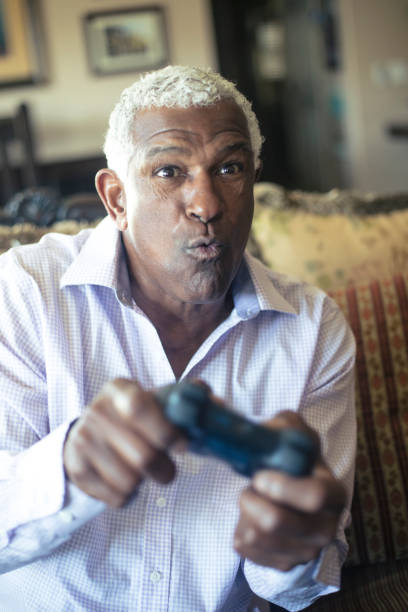 istock Senior Black Man Playing Video Games 935698538
