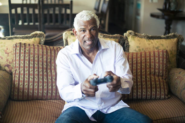 istock Senior Black Man Playing Video Games 935698652