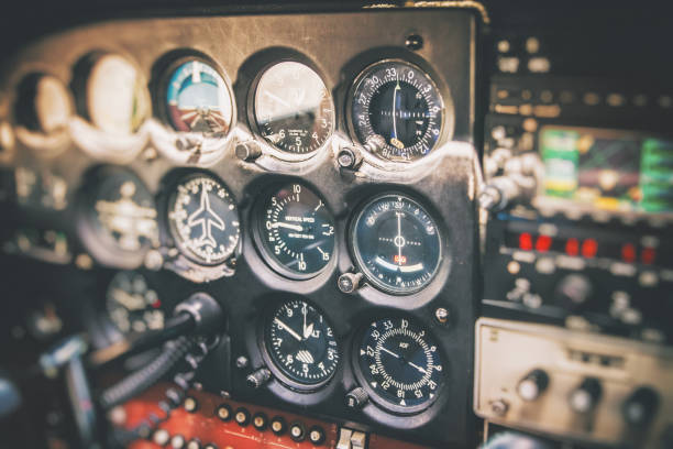 Close-up on flight instruments in old small airplane cockpit interior control panel in selective focus Vibrant color photography horizontal composition of close-up on several common flight instruments in old small propeller airplane cockpit interior without people in the frame, and selective focus on control panel dashboard. piloting photos stock pictures, royalty-free photos & images
